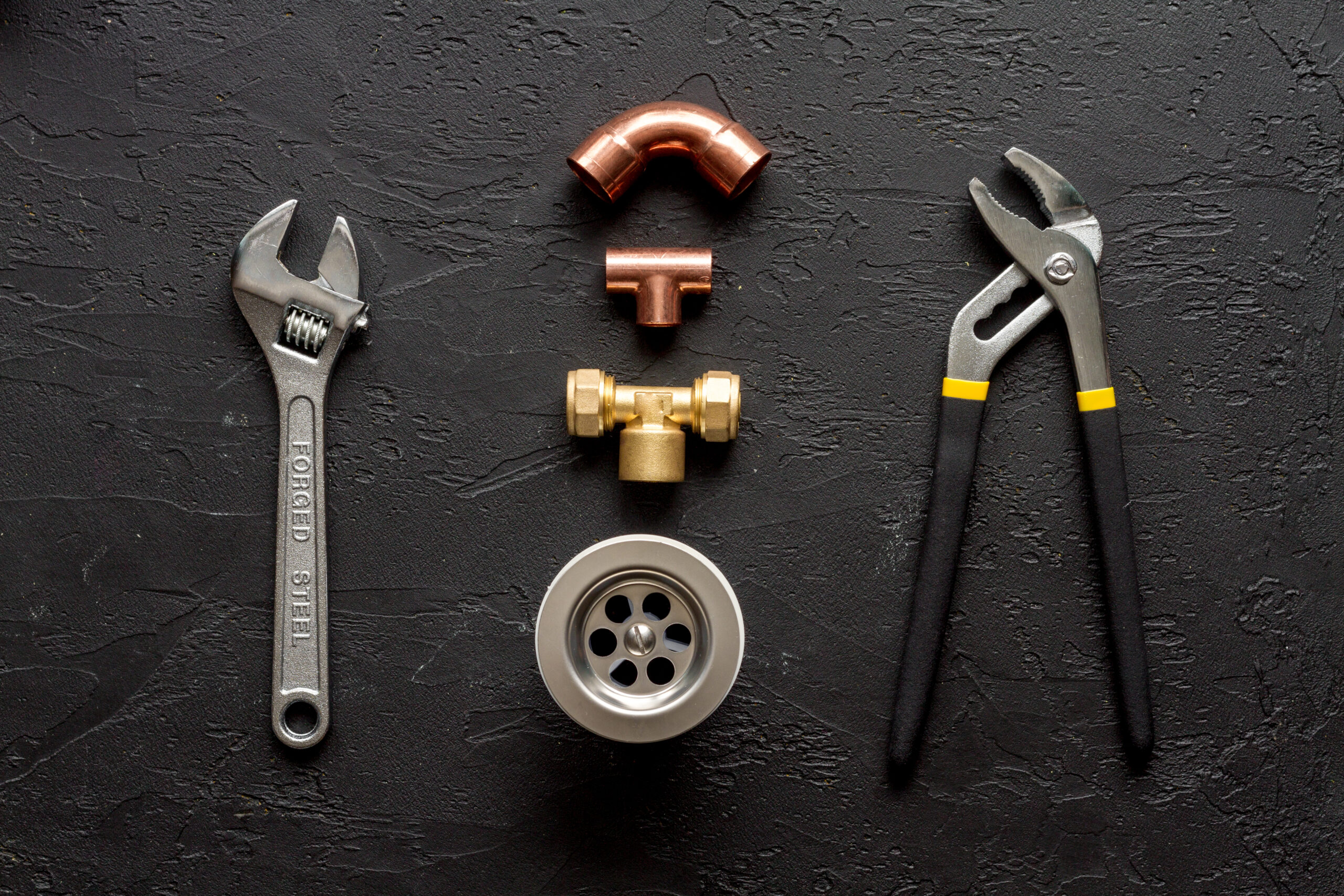 concept plumbing work top view on dark background Professional plumber checking a boiler and pipes, boiler service concept.